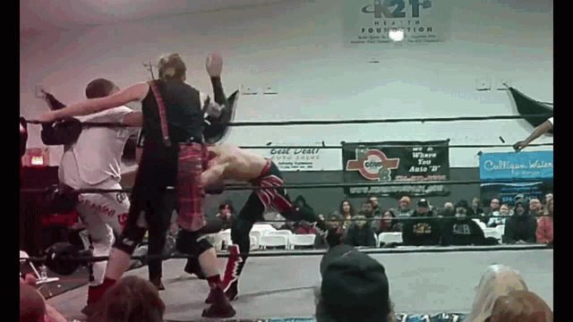 a wrestling match is being held in front of a sign that says k2f health foundation