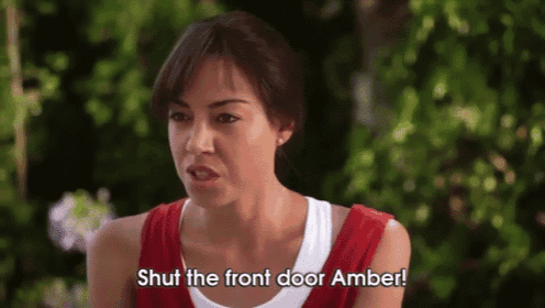a woman says shut the front door amber in a red tank top
