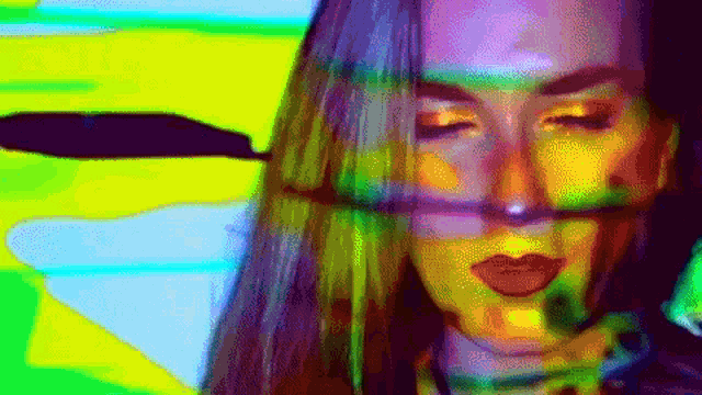 a close up of a woman 's face with a rainbow of colors behind her .