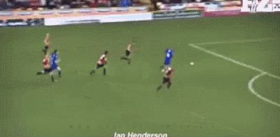 a soccer game is being played on a field with advertisements for sports identity in the background