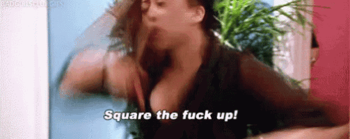 a woman with a huge breast is saying square the fuck up in a blurry photo .