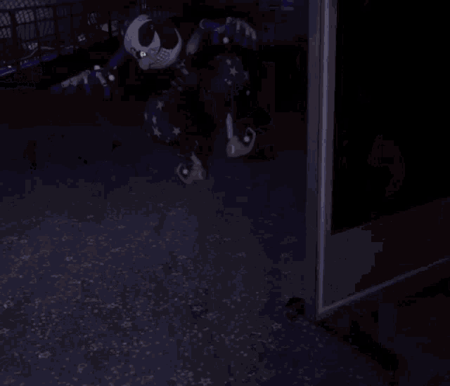 a skeleton clown is standing in a dark room
