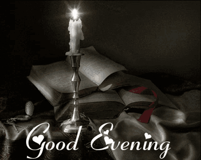 a candle is lit in front of an open book and the words good evening