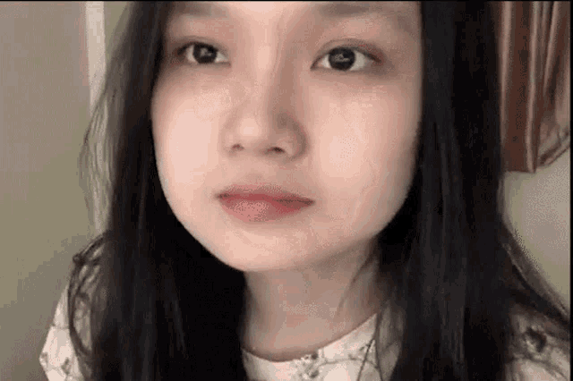 a close up of a woman 's face without makeup .