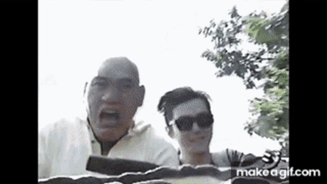 a man and a woman are riding a roller coaster together and making funny faces .