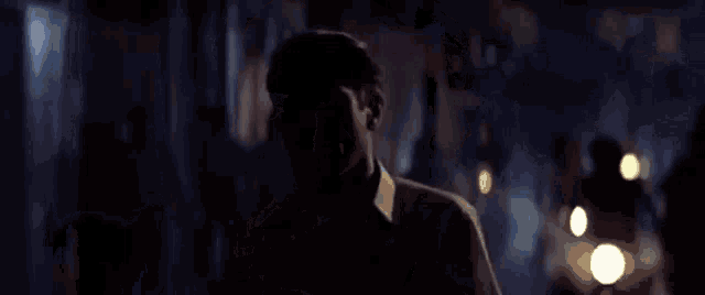a man 's face is visible in a dark room