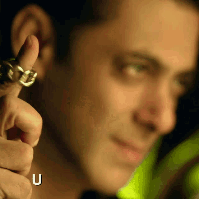 a close up of a man 's face with the letter u visible