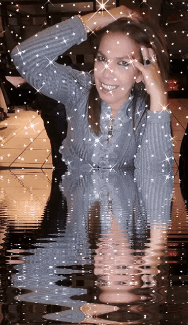 a woman with a ring on her finger is surrounded by sparkly stars