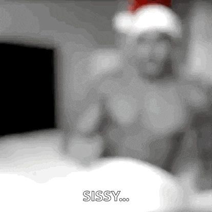 a blurry picture of a man wearing a santa hat with the words sissy written in the corner .