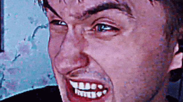 a close up of a man making a face with his mouth open