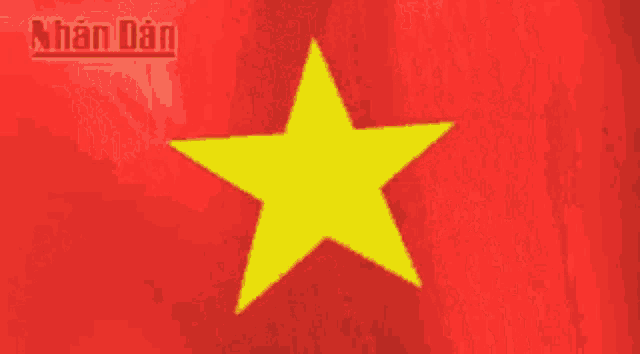 a red flag with a yellow star and the word nhan dan in the corner