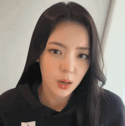 a woman with long hair is wearing a black hoodie