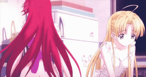a girl with red hair and a girl with blonde hair are standing next to each other .