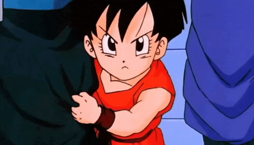 a little girl in a red dress from dragon ball z is standing next to a man in a blue shirt .