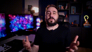 a man with a beard is sitting at a desk in front of a computer screen with the word pop on it .