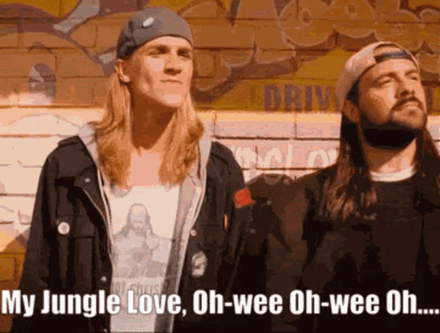 two men are standing in front of a brick wall with the words my jungle love oh-wee oh-wee oh on the bottom
