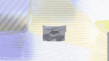a person wearing a hat and a hood is standing in front of a striped wall .