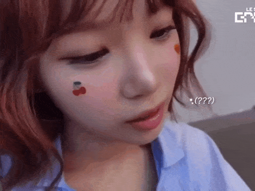 a close up of a woman with a cherry on her face .