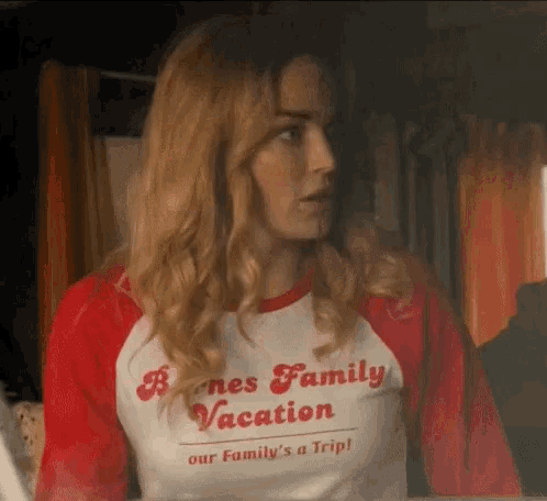 a woman wearing a red and white t-shirt that says barnes family vacation