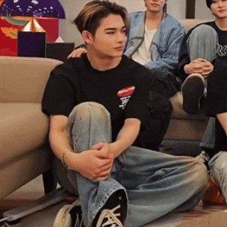 a man sitting on the floor with his legs crossed