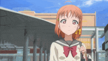 a girl in a school uniform with a red bow is holding a bag