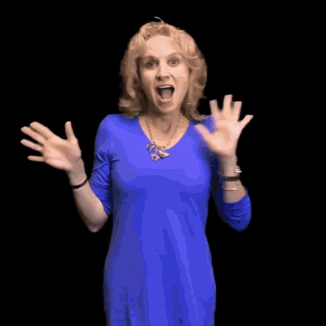 a woman in a blue shirt is making a surprised gesture