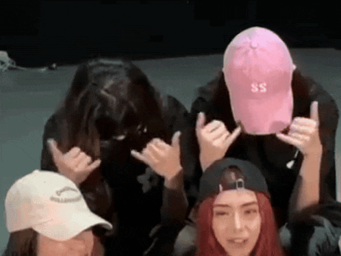 a woman wearing a pink hat with the letter s on it