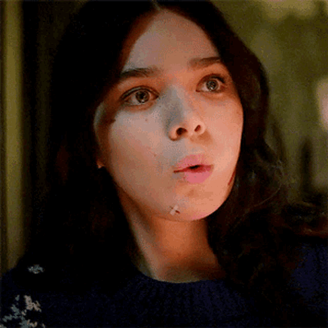 a close up of a woman 's face with a bandage on her chin