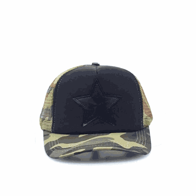 a camouflage hat with a black star on top