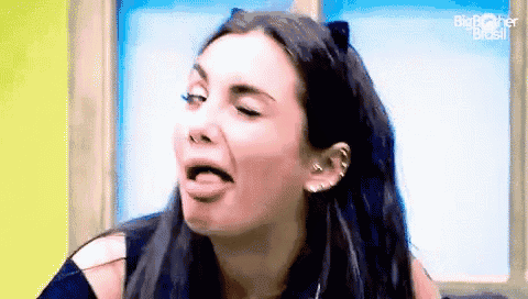 a woman is making a funny face with her tongue hanging out .