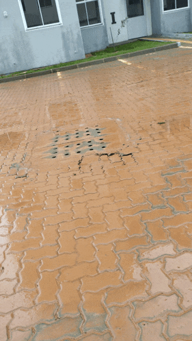 a brick driveway with the letter i in the doorway