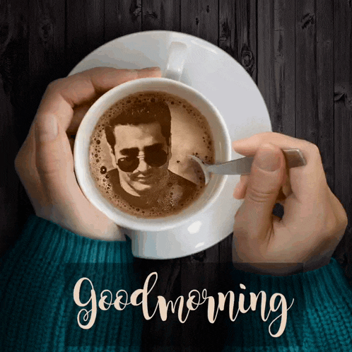 someone is holding a cup of coffee with a picture of a man on it
