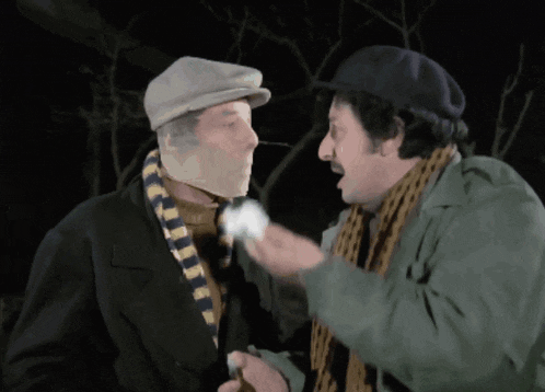 a man with a bandage on his face is talking to another man with a scarf around his neck