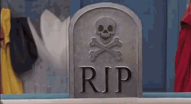 a tombstone with a skull and crossbones and the word rip on it