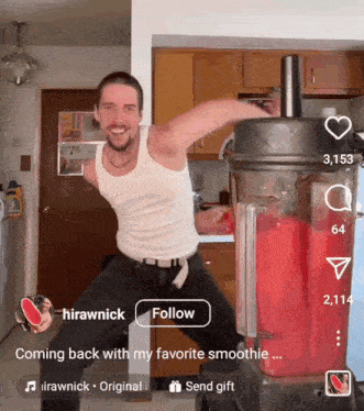 a man is standing in front of a blender and holding a watermelon slice