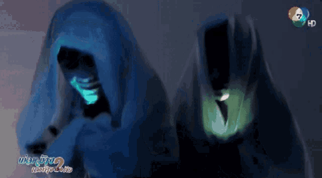 two people are covered in a blue blanket with a 7 hd logo on the bottom