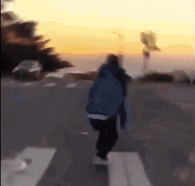 a blurry picture of a person walking on a street