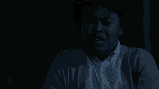 a man with a surprised look on his face is wearing a white shirt