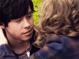 a man and a woman are looking at each other .