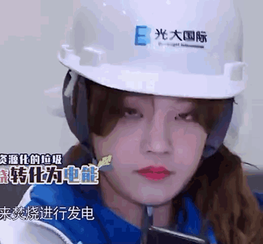 a woman wearing a hard hat with the letter e on the front