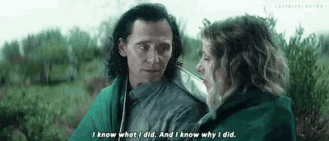 loki and a woman are standing next to each other in a field .