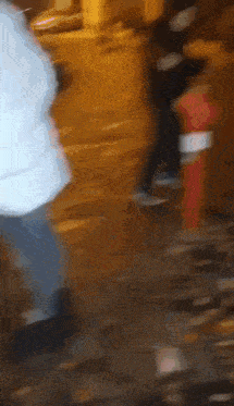 a blurry picture of a person walking down a street