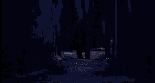 a man in a mask is doing a split in the dark while holding a knife .