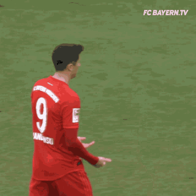 two soccer players on a field with fc bayern.tv in the corner
