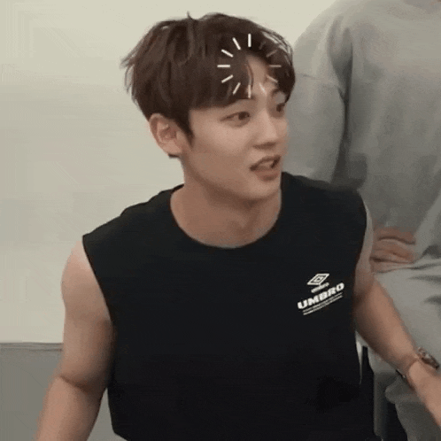 a young man wearing a black tank top with umbro on it
