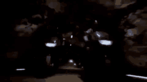 a dark room with a lot of lights on and a person standing in the dark .