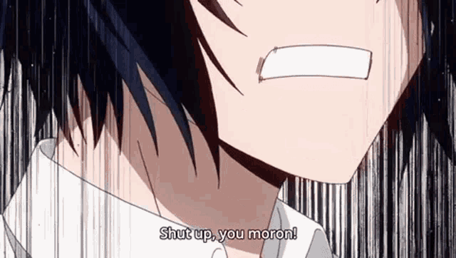a close up of a man 's face with the words `` shut up , you moron '' written on it .