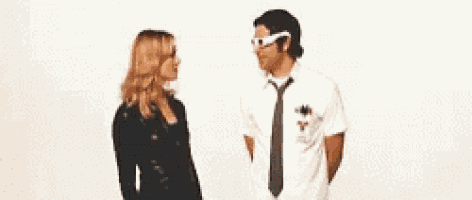 a woman is putting a bandage on a man 's head