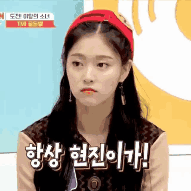 a woman wearing a red hat and a headband with foreign writing on it