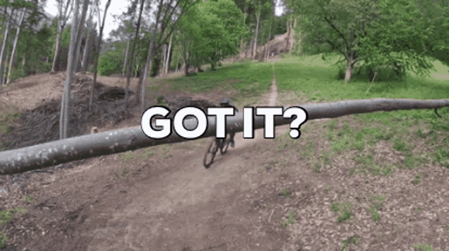 a person riding a bike on a trail with the words got it written above them